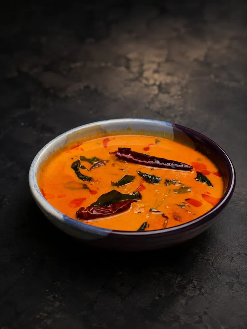 Meen Manga Curry in a ceramic bowl