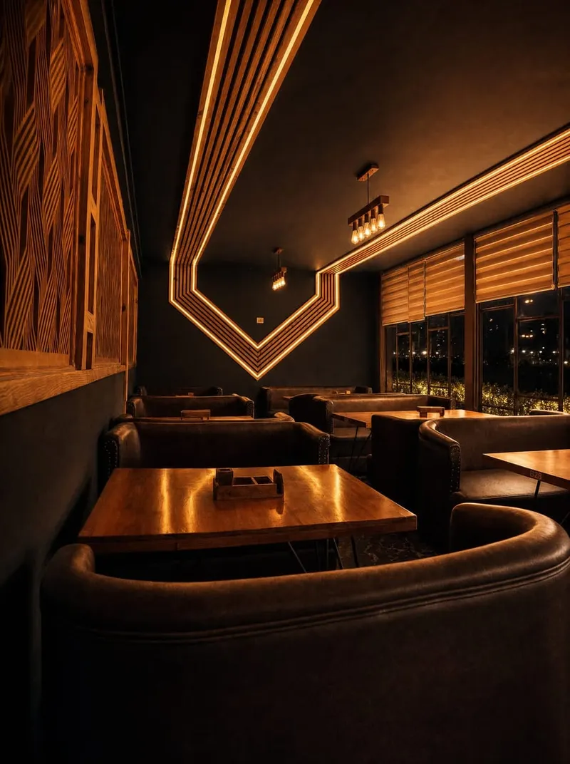 Dark booth seating with angled wood-and-light detailing